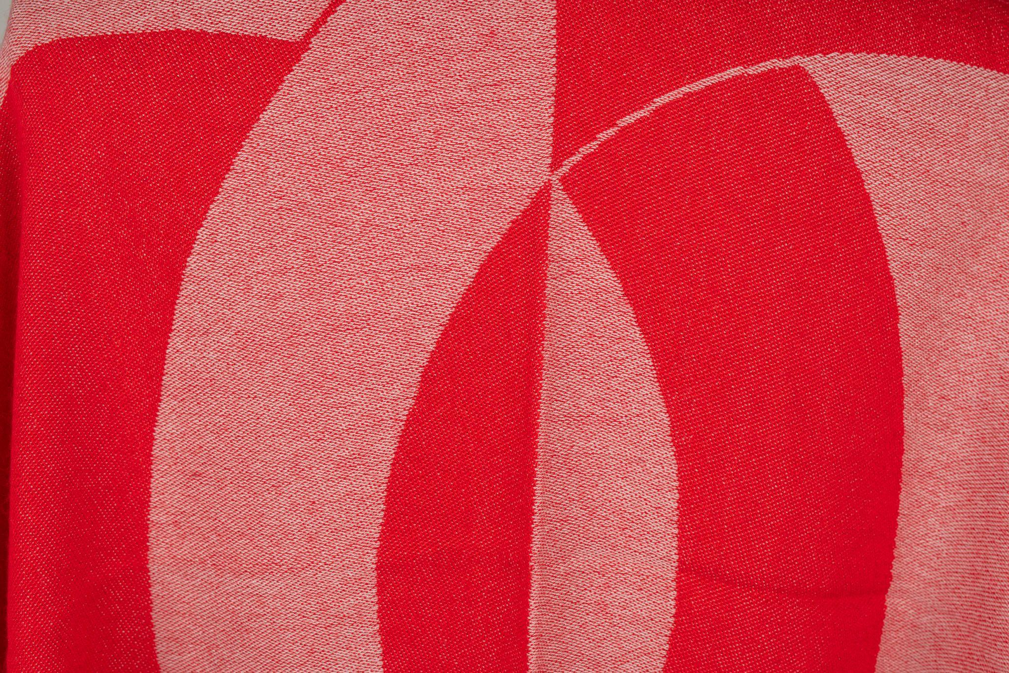 Chanel Cashmere Shawl in red. The pattern features one big CC logo as the center piece. Also Chanel is written on the shawl. The item is in new condition.
