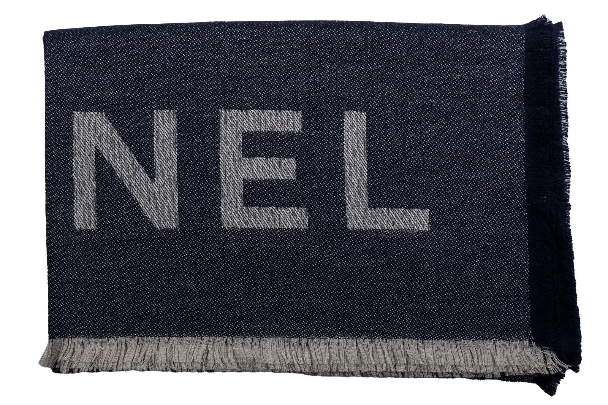 Chanel Cashmere Shawl in navy. The pattern features one big CC logo as the center piece and Chanel is written on it. The item is in new condition.