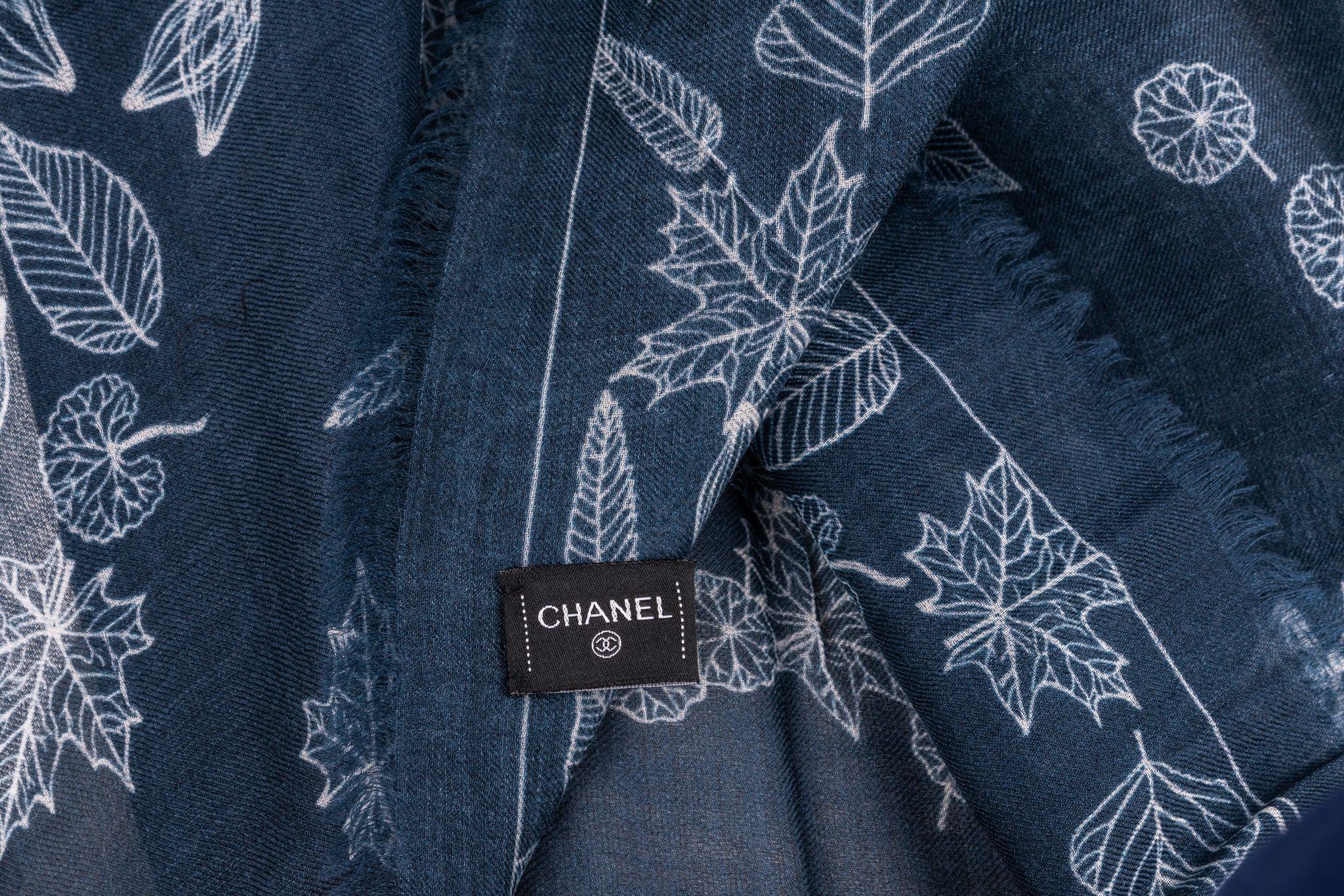 Chanel Cashmere Shawl in navy with a big CC logo in the center. The logo is designed with leaves so is the frame of the scarf. The item is in new condition.