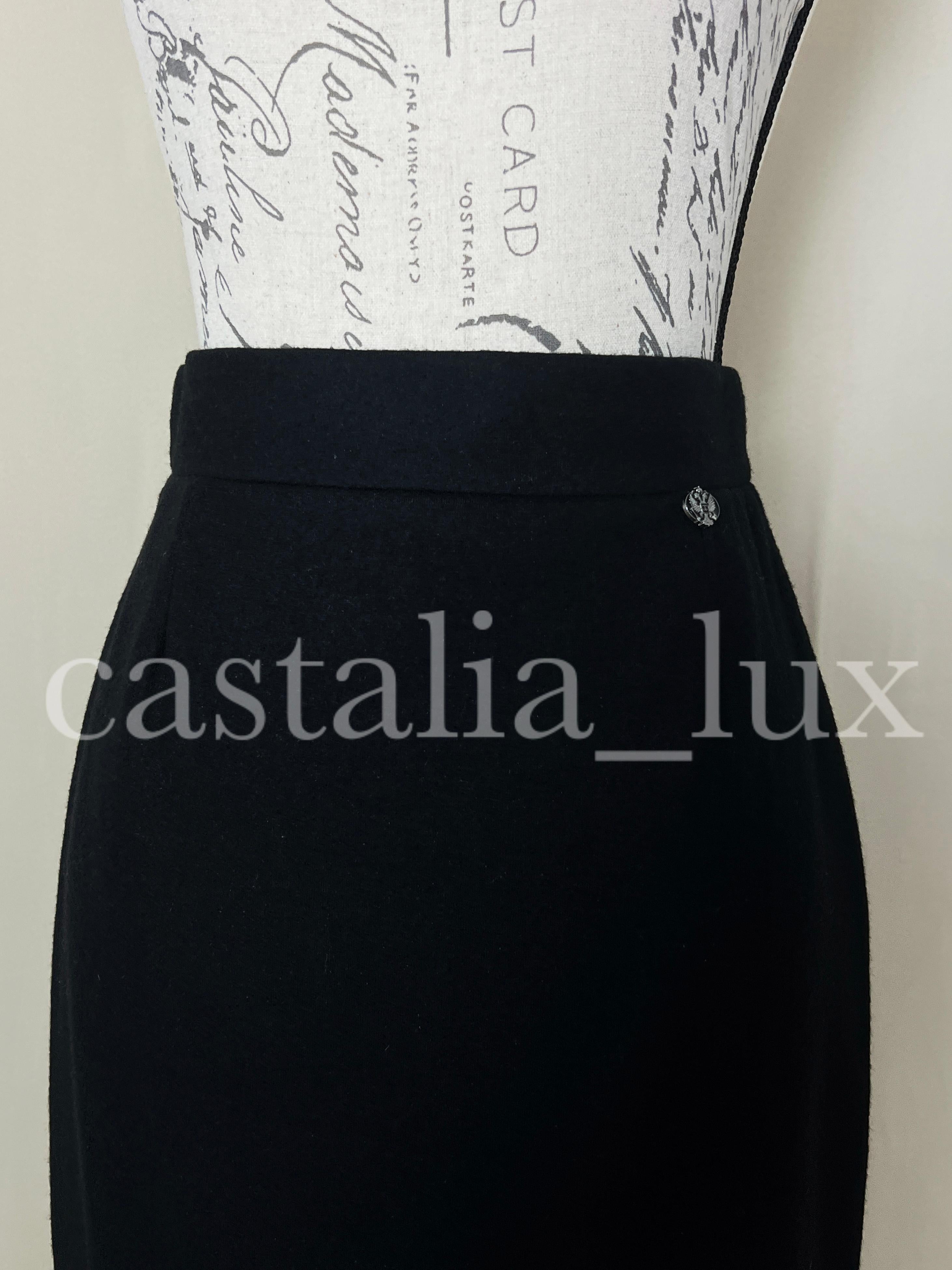 New black pencil skirt Chanel with CC logo eagle charm at waist.
Silk lining, size mark 38 FR. Never worn.