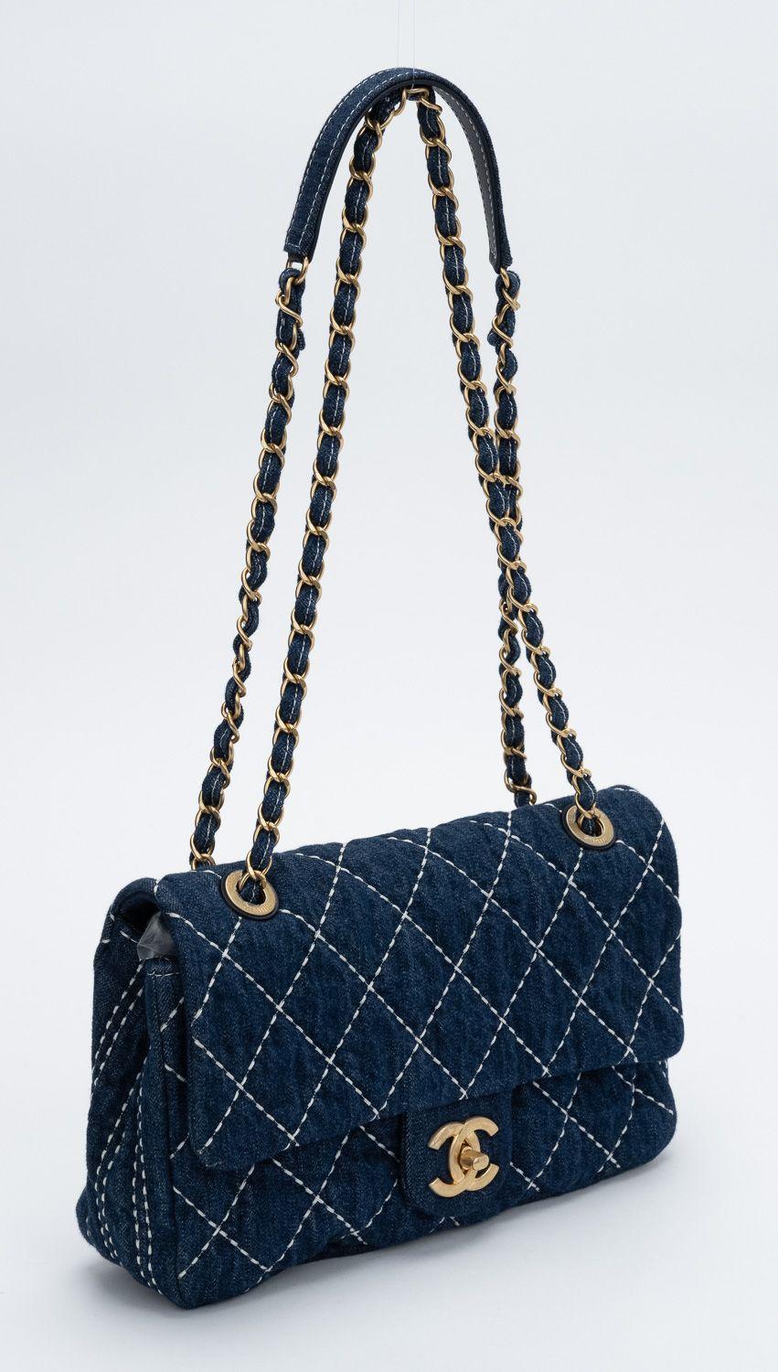 This Chanel Denim Quilted Denim Trip Single Flap bag is finely crafted of diamond quilted blue denim with white contrast stitching. The bag features aged gold chain straps and an oversized CC turn lock, it opens to a matching denim interior with a