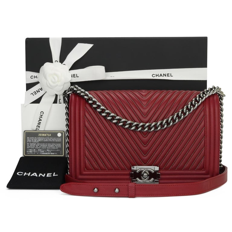CHANEL New Medium Chevron Boy Bag Dark Red Embroidered Thin Chains Calfskin with Light Gunmetal Hardware 2014.

This stunning bag is still in very good condition; it still keeps its shape, and the hardware is very shiny. It is a limited edition