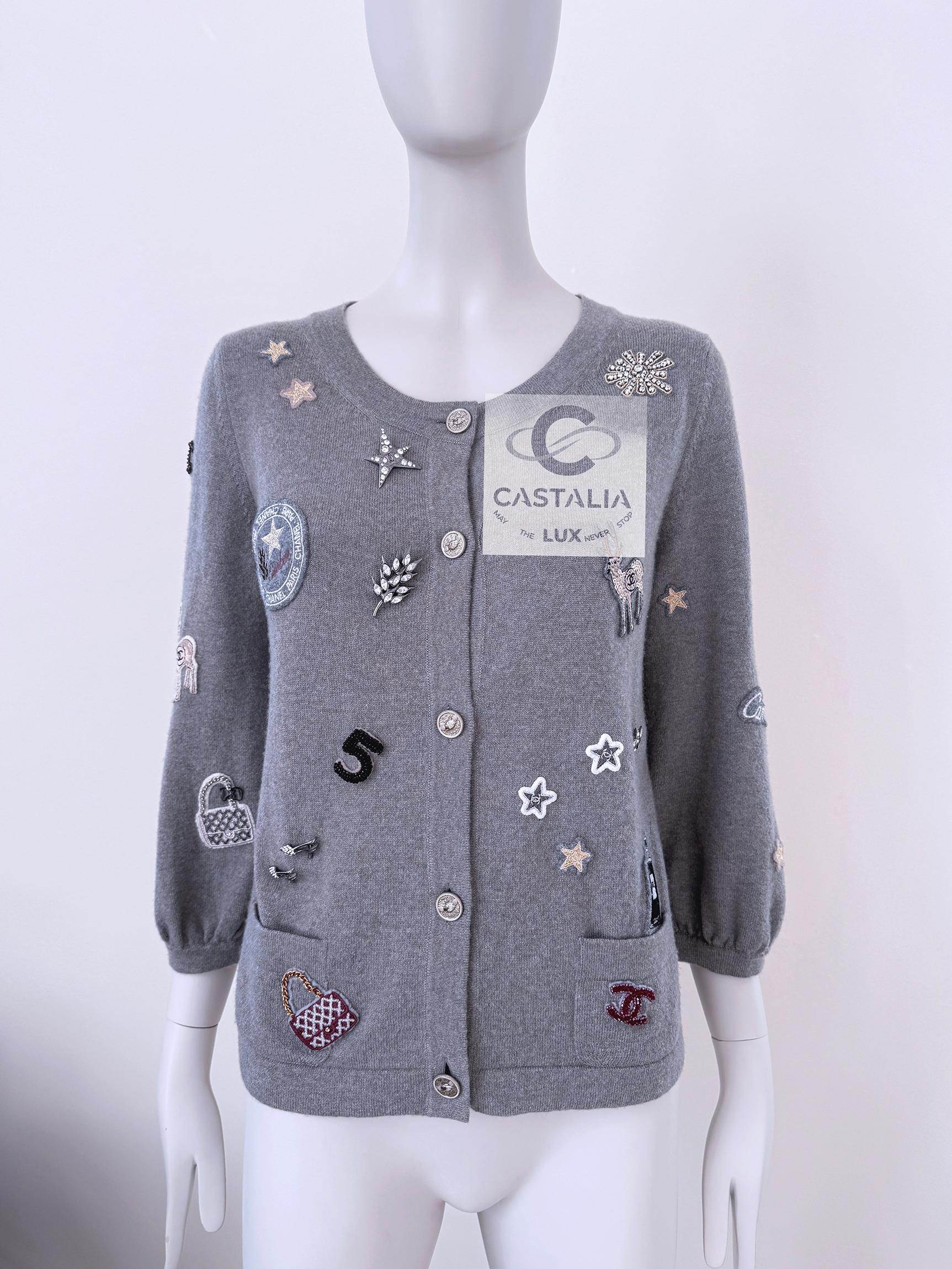 Rare, collectible piece!
Iconic Chanel grey cashmere cardigan with Lucky Charms & Chanel's most recognisable symbols ~ Bags, no 5 Bottle Perfume, 31 Rue Cambon patches, etc
- CC logos embellished allover
- CC logo 'shaking hands' buttons ~ at front