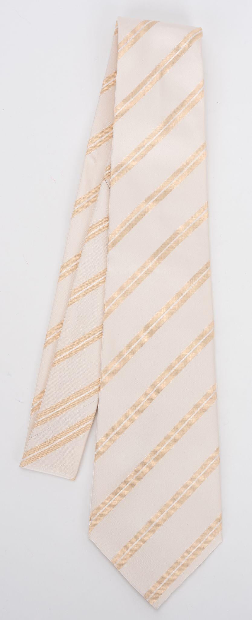 Chanel brand new 100% silk tie in cream regimental pattern. Composition label, brand label and signature chain. Comes with original envelope .