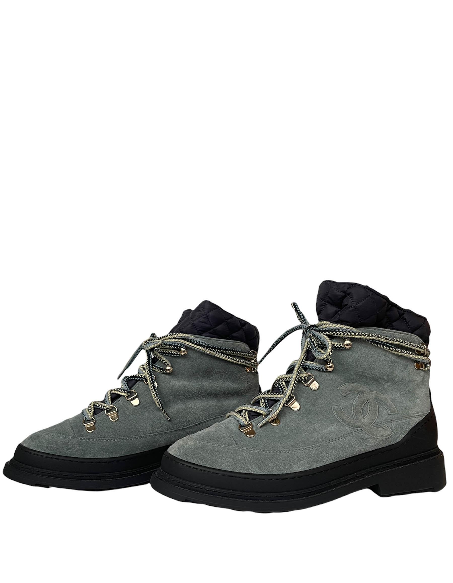 Chanel NEW Slate Blue Suede Logo High Top Lace Up Boots.  Features navy nylon quilted insert and shearling lining.  Soles feature optional snow grips that can be tucked away into the sole with the included tool.

Made In: Italy
Color: Bluish grey,