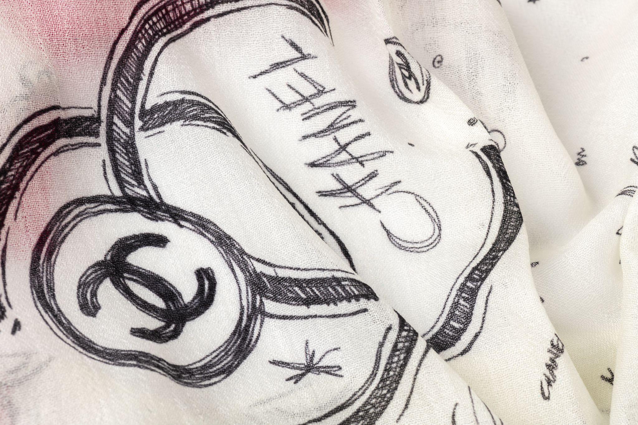 Chanel new cashmere shawl in white with fuchsia trim. Black logo drawings. Care tag attached.