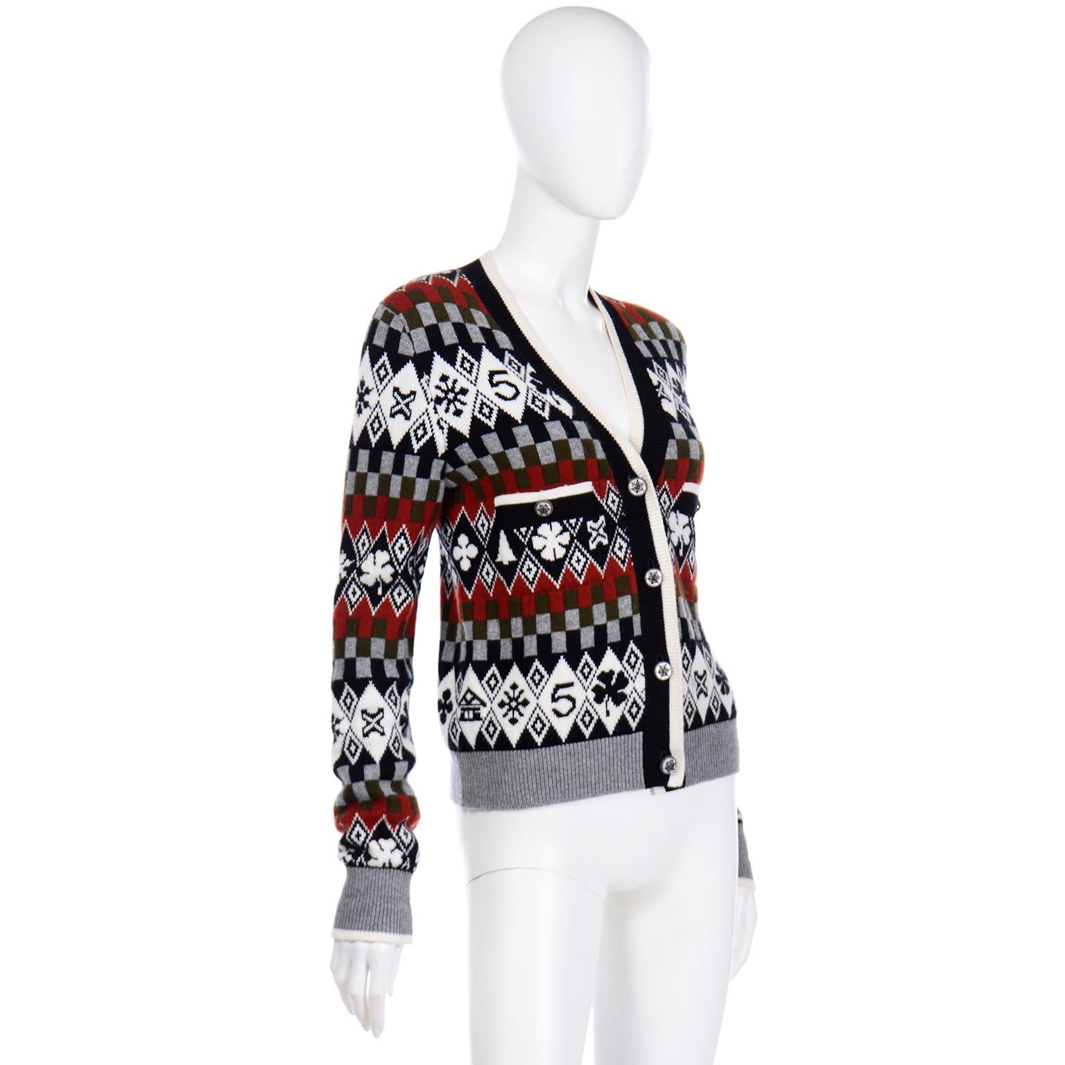 This is a 2019 Chanel NWT cardigan sweater from the last collection designed by Karl Lagerfeld for Chanel. The snowy runway at the Grand Palais, was a fantastical winter wonderland. This cardigan is in a  winter print that includes camellias,