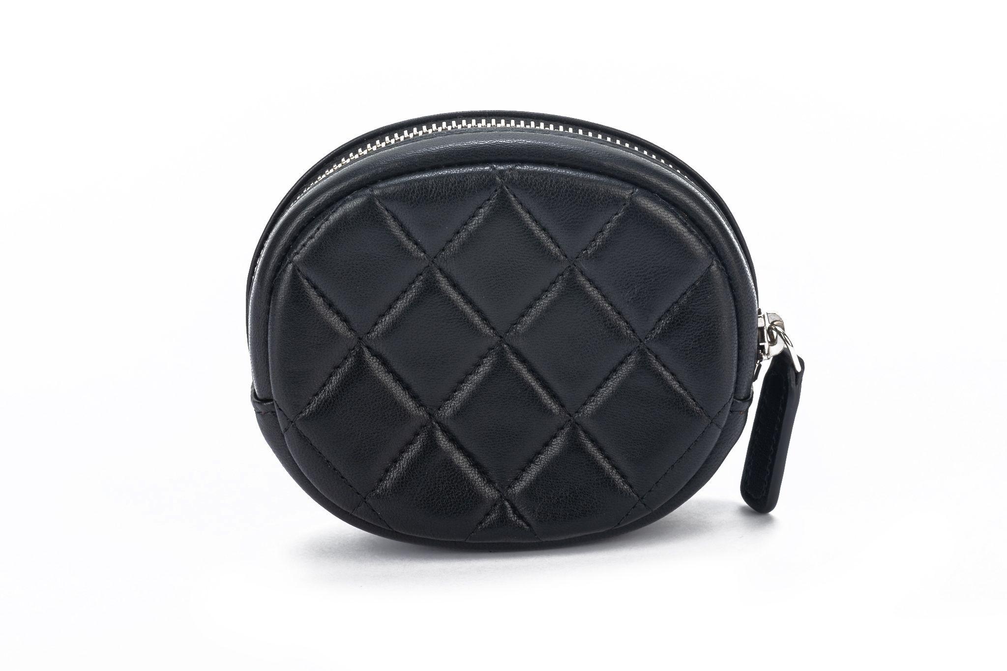 Chanel new in box oval black quilted caviar coin case with silver logo. Collection 29. Comes with hologram, ID card, booklet, dust cover and box.