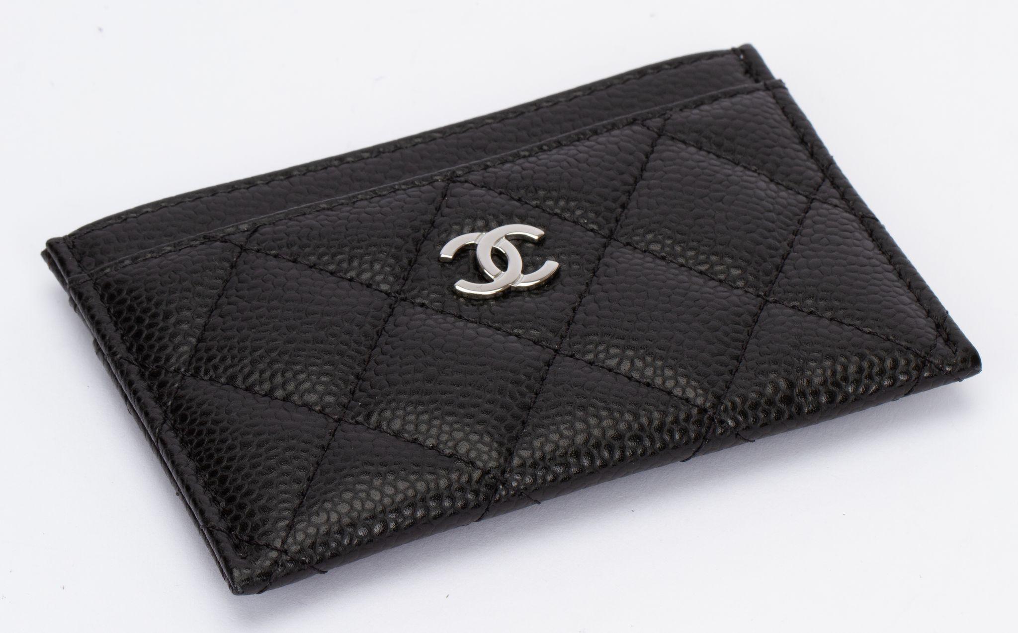 Chanel Caviar Quilted Card Holder in Black. This card case is made of diamond-quilted caviar leather in black. The case has card slots on either side of the main compartment, with a polished silver Chanel CC logo on the front.It is brand new and