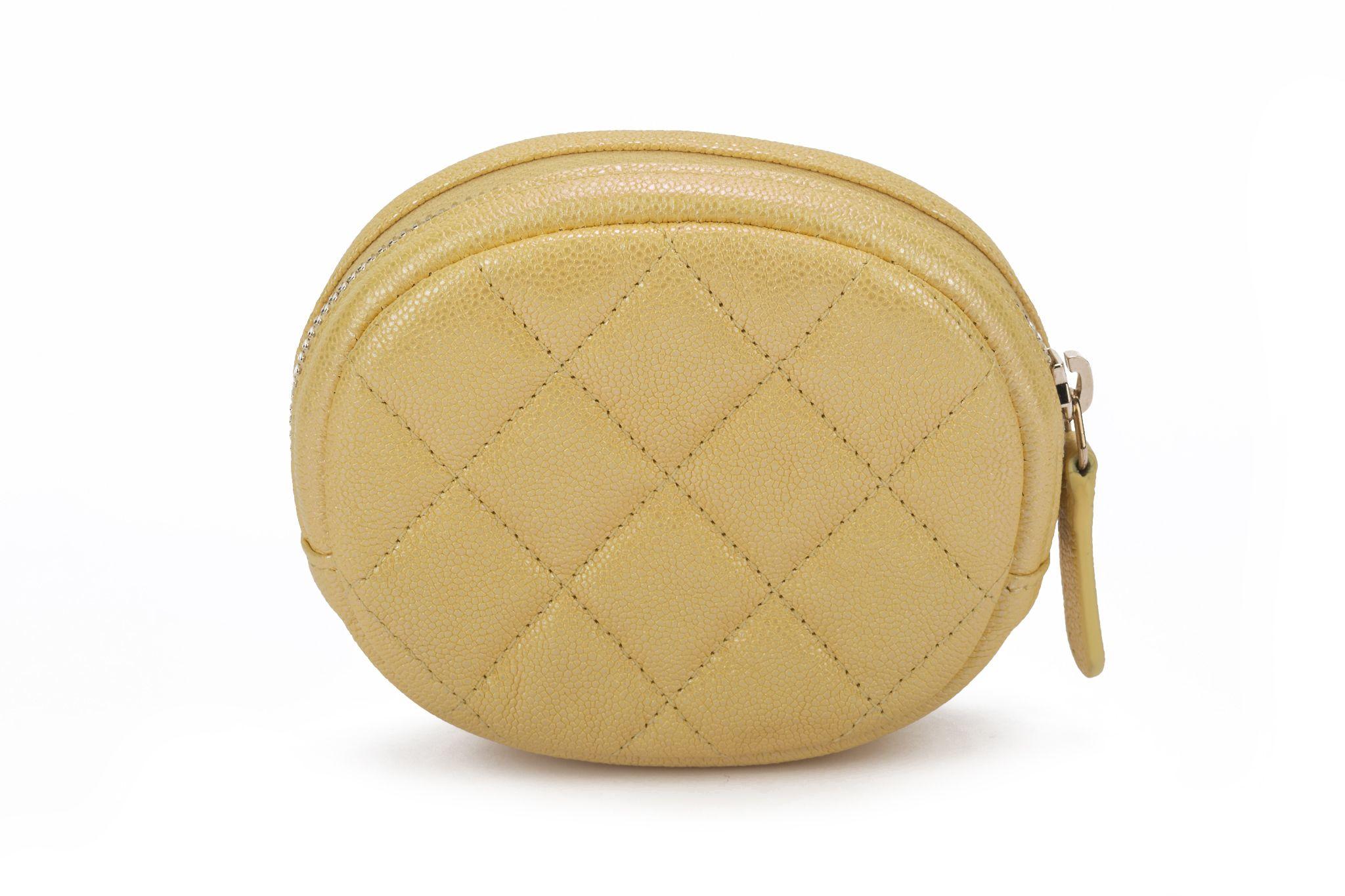 Chanel new in box oval iridescent yellow quilted caviar coin case with yellow gold logo. Collection 27. Comes with hologram, ID card, booklet, dust cover and box.