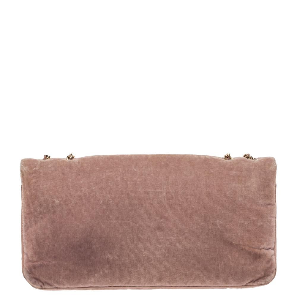 Crafted with precision from luxurious velvet, and enveloped in a nude pink shade, this flap bag from Chanel cannot get any more stunning than it already is! This piece brings the signature Mademoiselle lock on the flap and it leads to nylon-lined