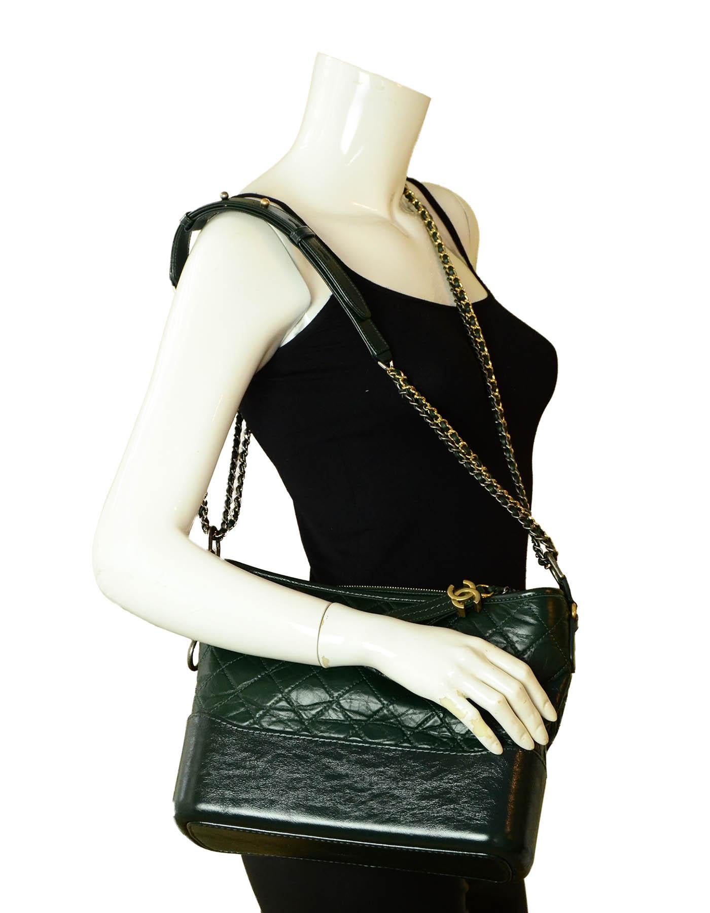 Chanel NWT 17A Distressed Dark Green Gabrielle Hobo Bag

Made In: Italy
Year of Production: 2017
Color: Dark Green
Hardware: Goldtone, silvertone & ruthenium chain
Materials: Aged calfskin leather
Lining: Red grosgrain
Closure/Opening: