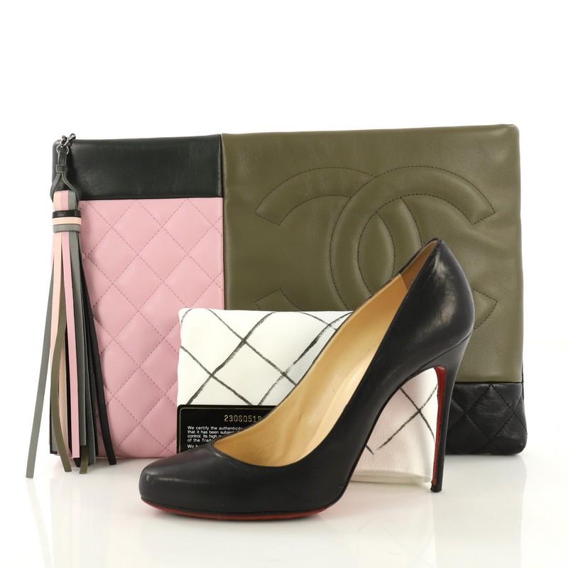 This Chanel O Case Clutch Colorblock Leather Large, crafted from multicolor leather, features a CC logo on the front and aged silver-tone hardware. Its zip closure opens to a green nylon interior. Hologram sticker reads: 23060519. **Note: Shoe