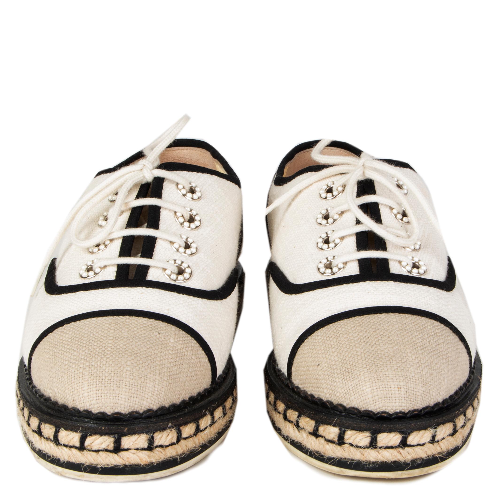 100% authentic Chanel espadrille lace-up tennis style sneakers in oatmeal and off-white canvas featuring black silk trimming and pearl-buttons. Have been worn and are in excellent condition. Come with dust bag.

Measurements
Imprinted Size	37
Shoe