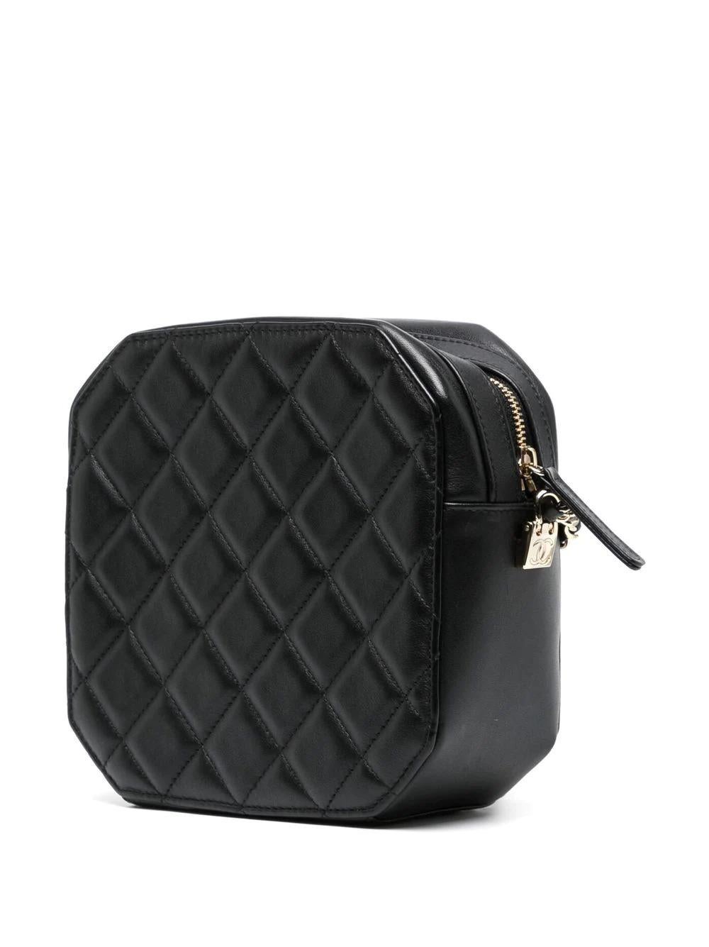 Camera bags are named for their practical, compact shape. Crafted from black lambskin, this pre-owned Chanel bag from 2021 features the brand's signature CC logo on one side and quilted detailing on the other. Wear it across the body or over your