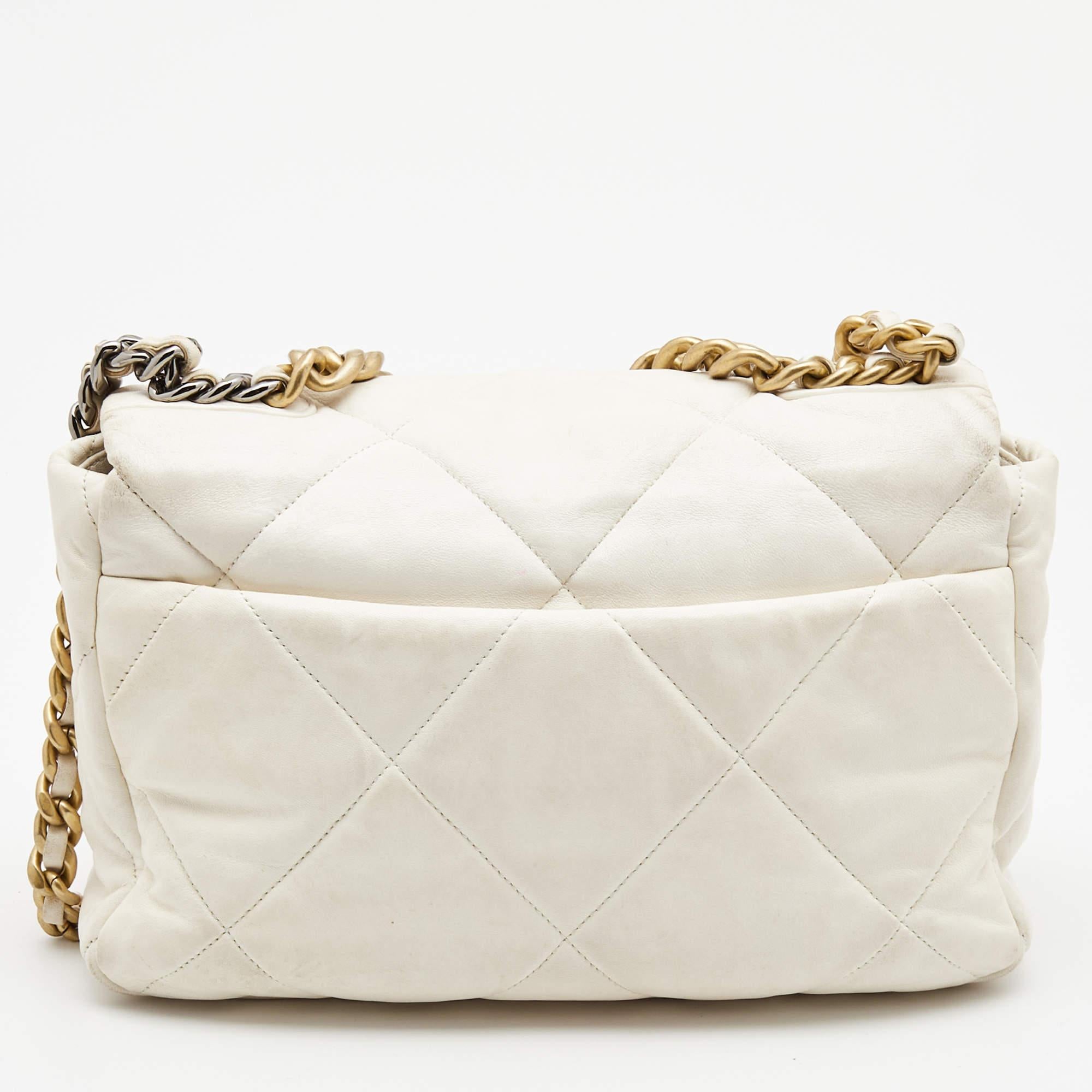 First unveiled in the Chanel Fall 2019 collection, the Chanel 19 bag is named after the year of its release, just like the Chanel 2.55. In design, the bag has exaggerated quilting and hardware in two tones. This version in off-white is made from