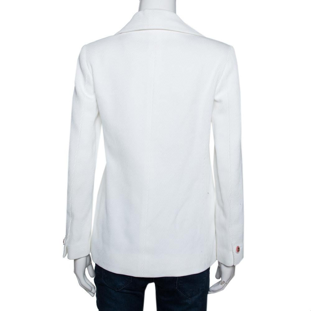 Chanel designs are known for class and elegance, and this jacket in soft off-white testifies to that. Made in cotton and lined with silk, the jacket features long sleeves and two external pockets. It comes with CC buttons and a comfortable fit. This