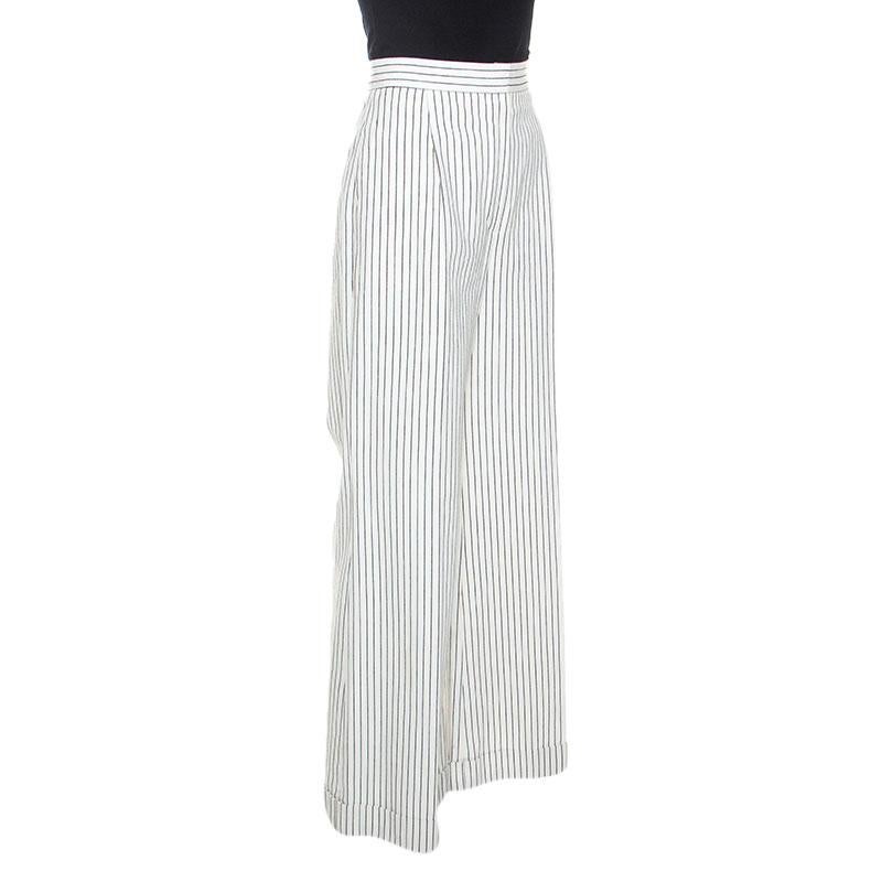 These trousers from the house of Chanel are tailored from 100% lightweight cotton and they look great. This off-white striped creation flaunts zip fastening and a wide-leg silhouette. These trousers will look fabulous with a complementing blouse and