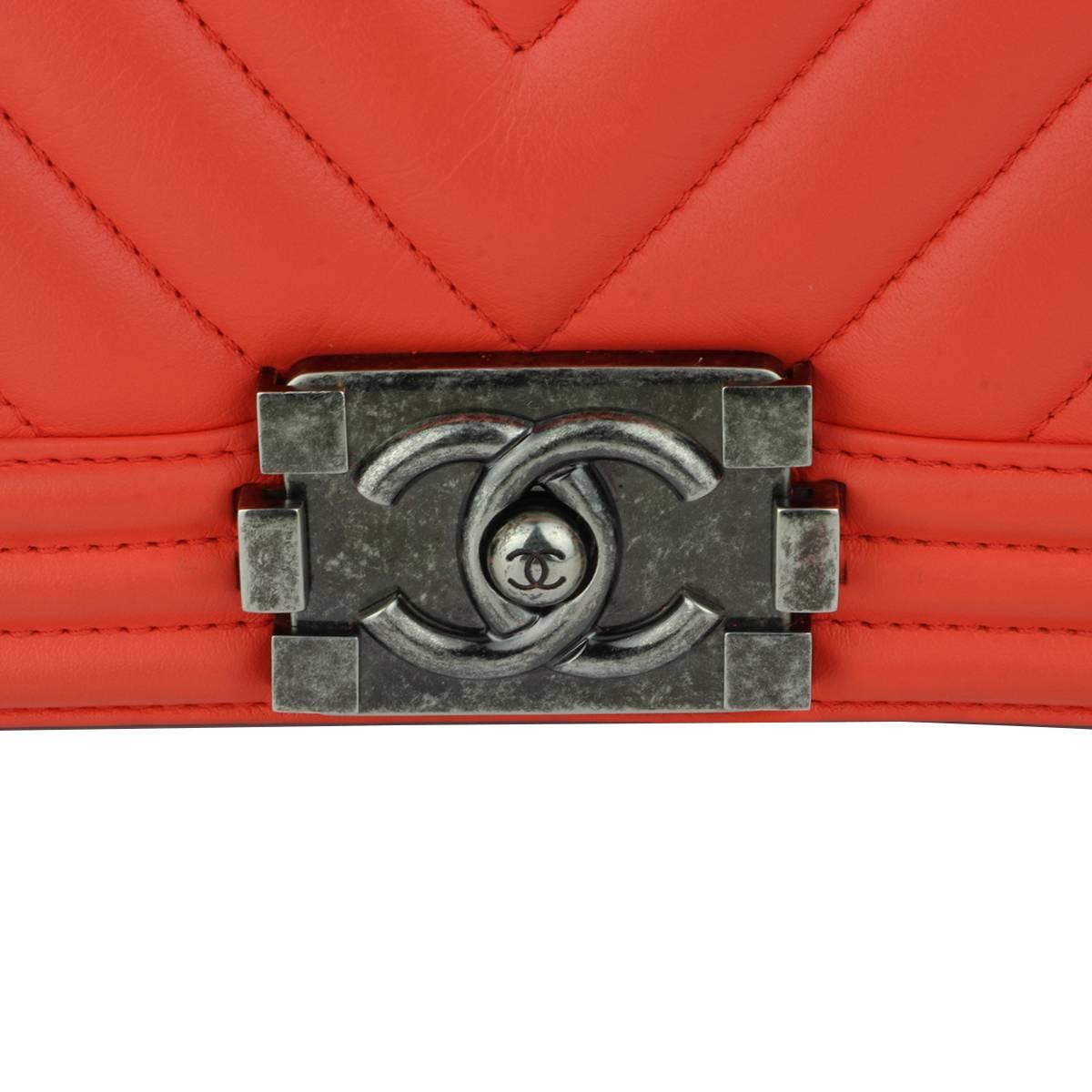 Authentic Chanel Old Medium Peachy Red Chevron LeBoy Calfskin with Ruthenium Hardware 2016.

This stunning bag is still in a mint condition, the bag still holds its original shape, and the hardware is still very clean and shiny. Calfskin leather