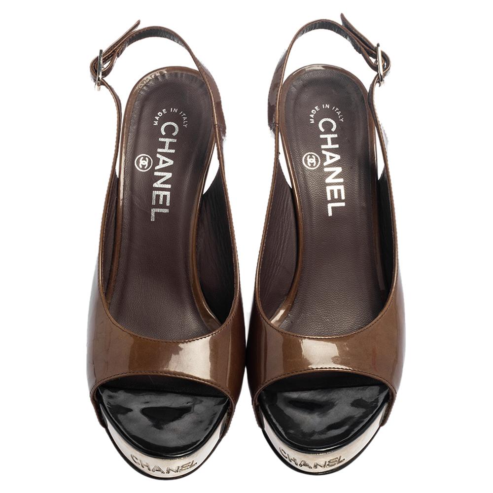 These gorgeous sandals from Chanel are amazing! The sandals are crafted from patent leather in a peep-toe silhouette. They flaunt buckle slingbacks, leather-lined insoles, and 11.5 cm heels supported by platforms.

