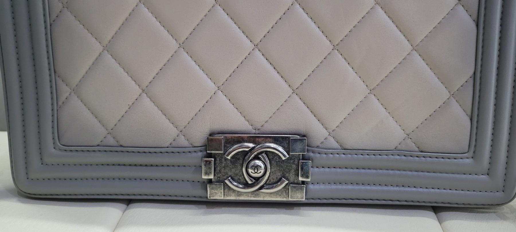 This is an authentic CHANEL Calfskin Ombre Quilted Large Boy Flap in Grey and Beige.
This chic shoulder bag is crafted of luxuriously soft lambskin diamond quilted leather with a linear quilted periphery in beige and grey. 
The bag features a dark