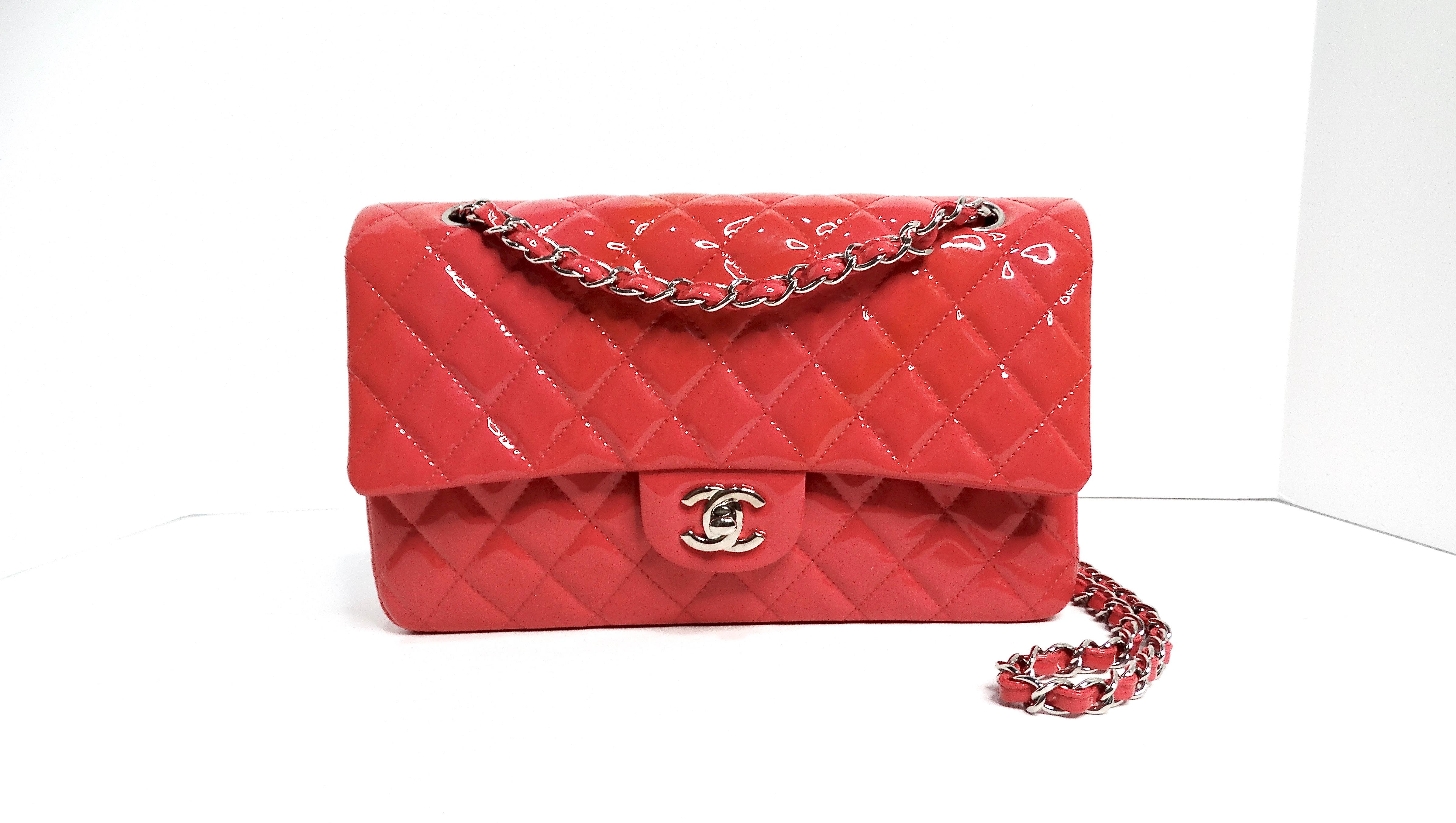 The Chanel Ombre Pink Patent Leather Medium Classic Double Flap Bag with Silver Hardware is a timeless piece that brings a touch of elegance and vibrancy to any wardrobe. This iconic medium-sized bag features a stunning ombre pink color, making it a
