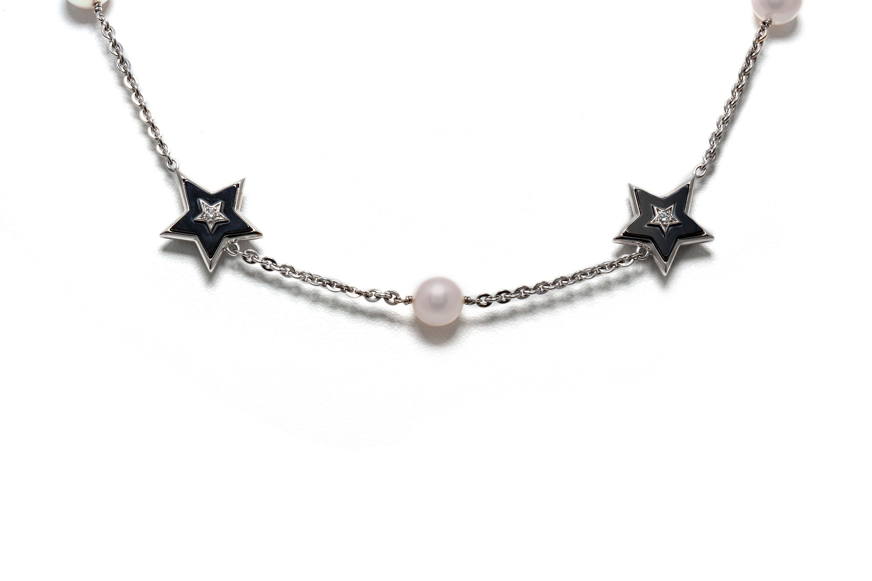 Chanel stars necklace, finely crafted in 18k white gold with pearls weighing approximately a total of 6.00 carats, onyx and diamonds.
