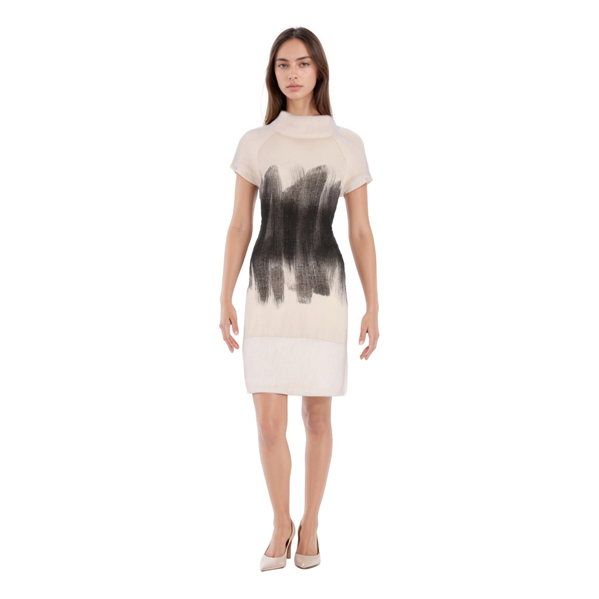 Chanel Open Back Angora & Cashmere Dress

Ivory mini jumper dress with rolled neckline and short sleeves.

Abstract brush design around the centre part of the body, wide ribbed hem.

Features open back and 'CC' logo pearl and crystal embellished