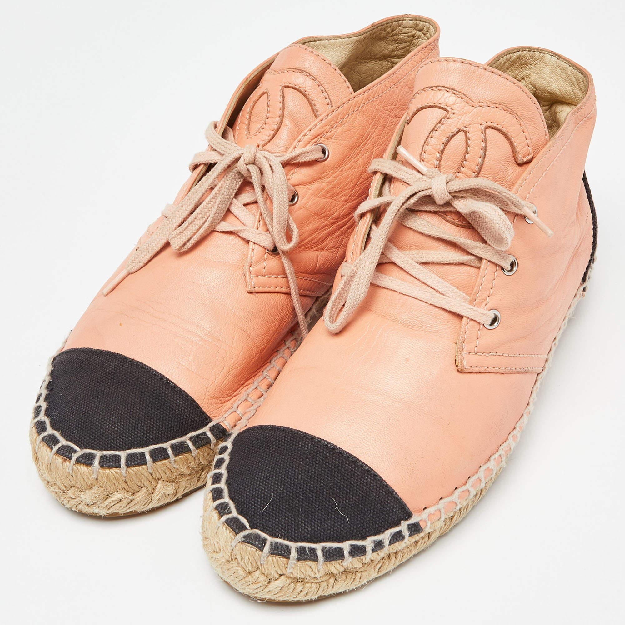 Step into fashion-forward luxury with these Chanel espadrille sneakers. These premium kicks offer a harmonious blend of style and comfort, perfect for those who demand sophistication in every step.