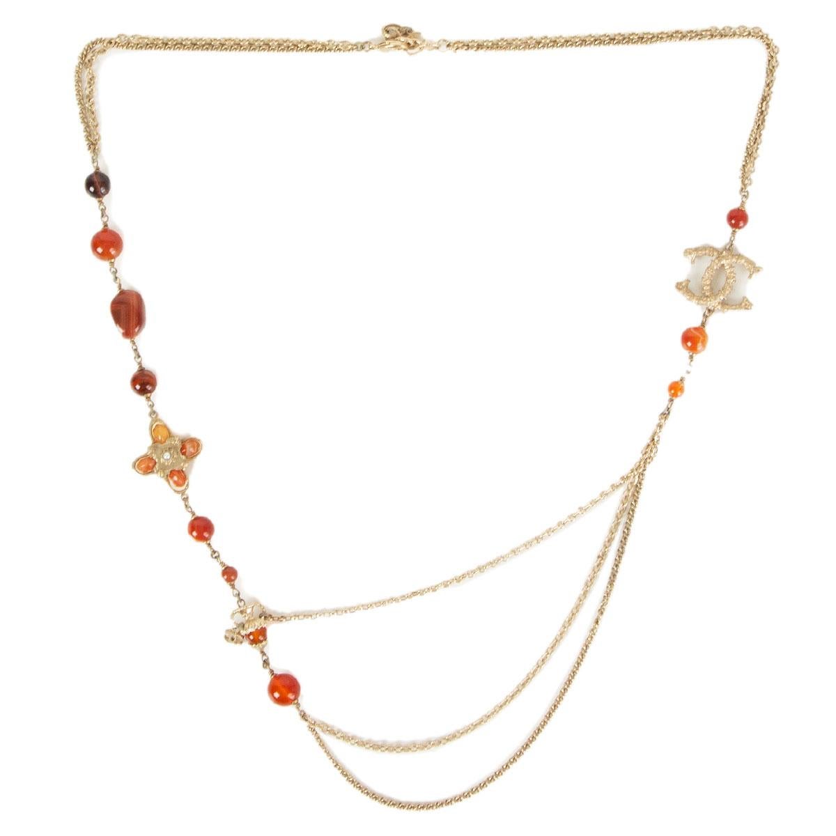 authentic Chanel Paris - Greece necklace in rust, orange, burgundy and honey colored faux stones embellished with CC logo in light-gold tone metal. Has been worn and is in excellent condition. 

Length 43cm (16.8in)
Hardware Light Gold-Tone

