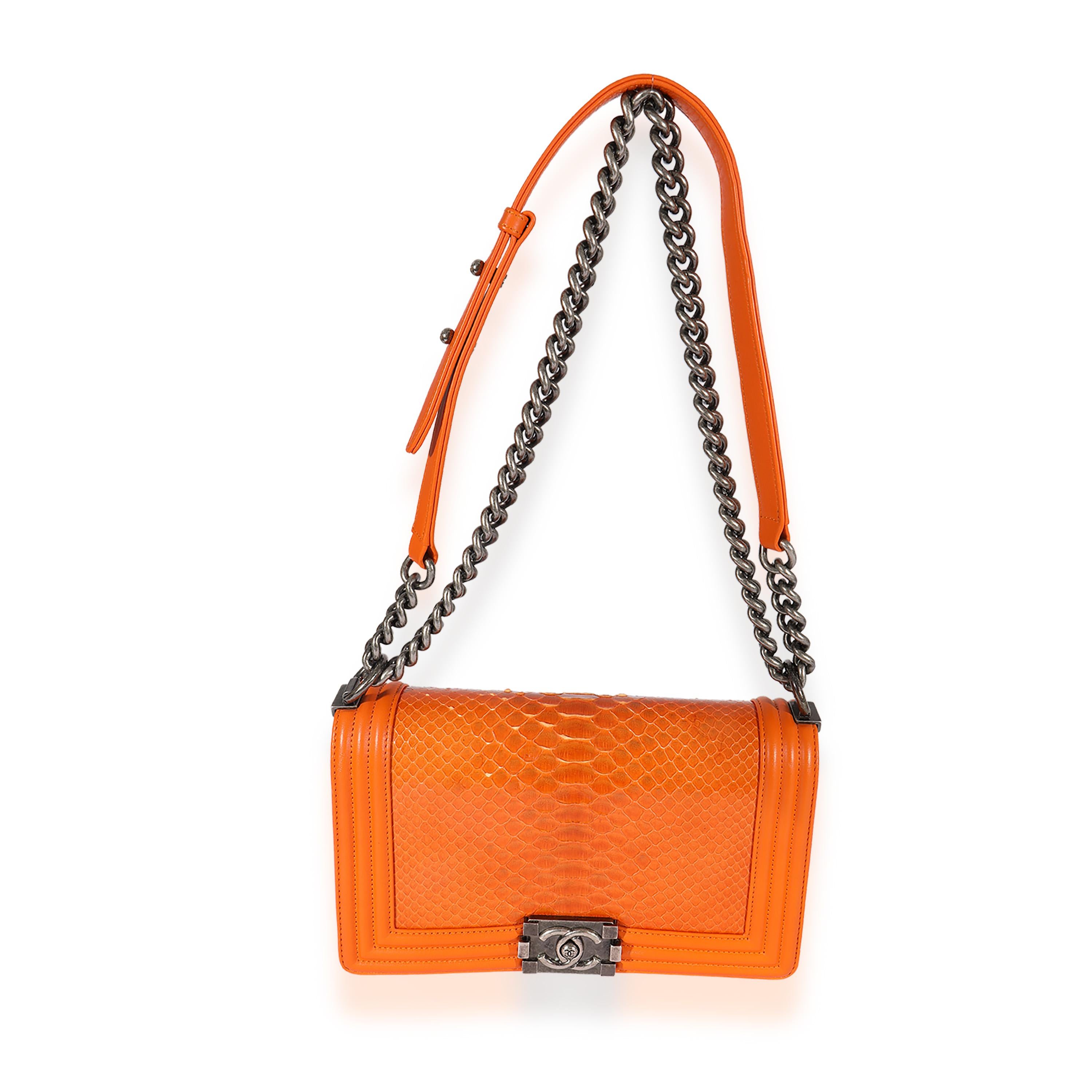 Listing Title: Chanel Orange Python Medium Boy Bag
SKU: 125528
Condition: Pre-owned 
Condition Description: An instant classic, the Boy bag from Chanel was introduced in 2011. The quilted bag was designed by the late Karl Lagerfeld, who was inspired