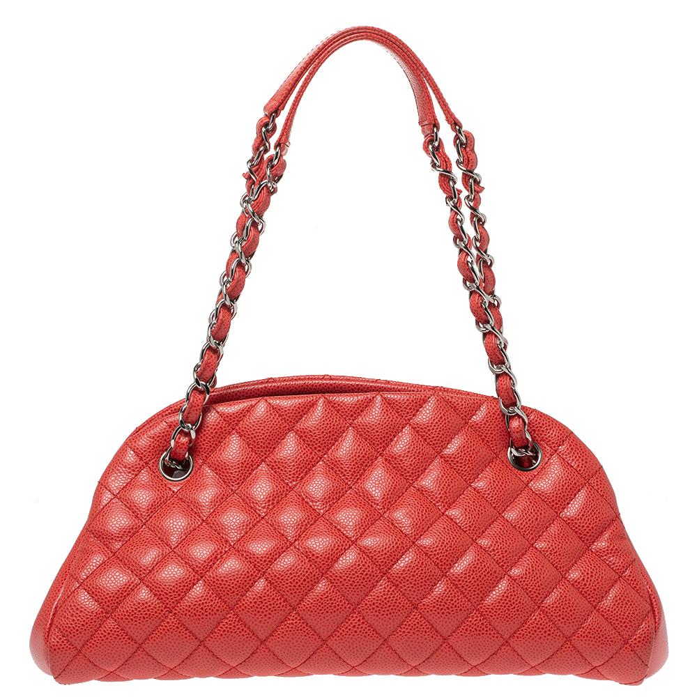 Spacious and captivating, this Just Mademoiselle Bowler bag is from Chanel. It has been crafted from leather and features the iconic quilted pattern. It is equipped with two chain handles and well-sized canvas compartments to keep your essentials