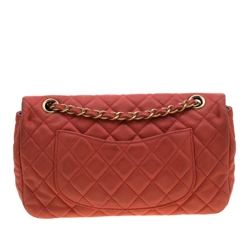 Chanel's classic flap bags are the most iconic handbags in the fashion world. Totally worth the splurge, these bags, that have become a symbol of class and luxury, carries unparalleled elegance and charm. This flap bag is crafted from orange