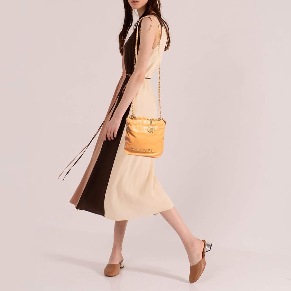 Experience the timeless charm of the Chanel 22 Chain Bag. Crafted from sumptuous quilted leather this exquisite mini bag features a sleek white hue complemented by a polished chain strap. Its compact size is ideal for essentials making it perfect
