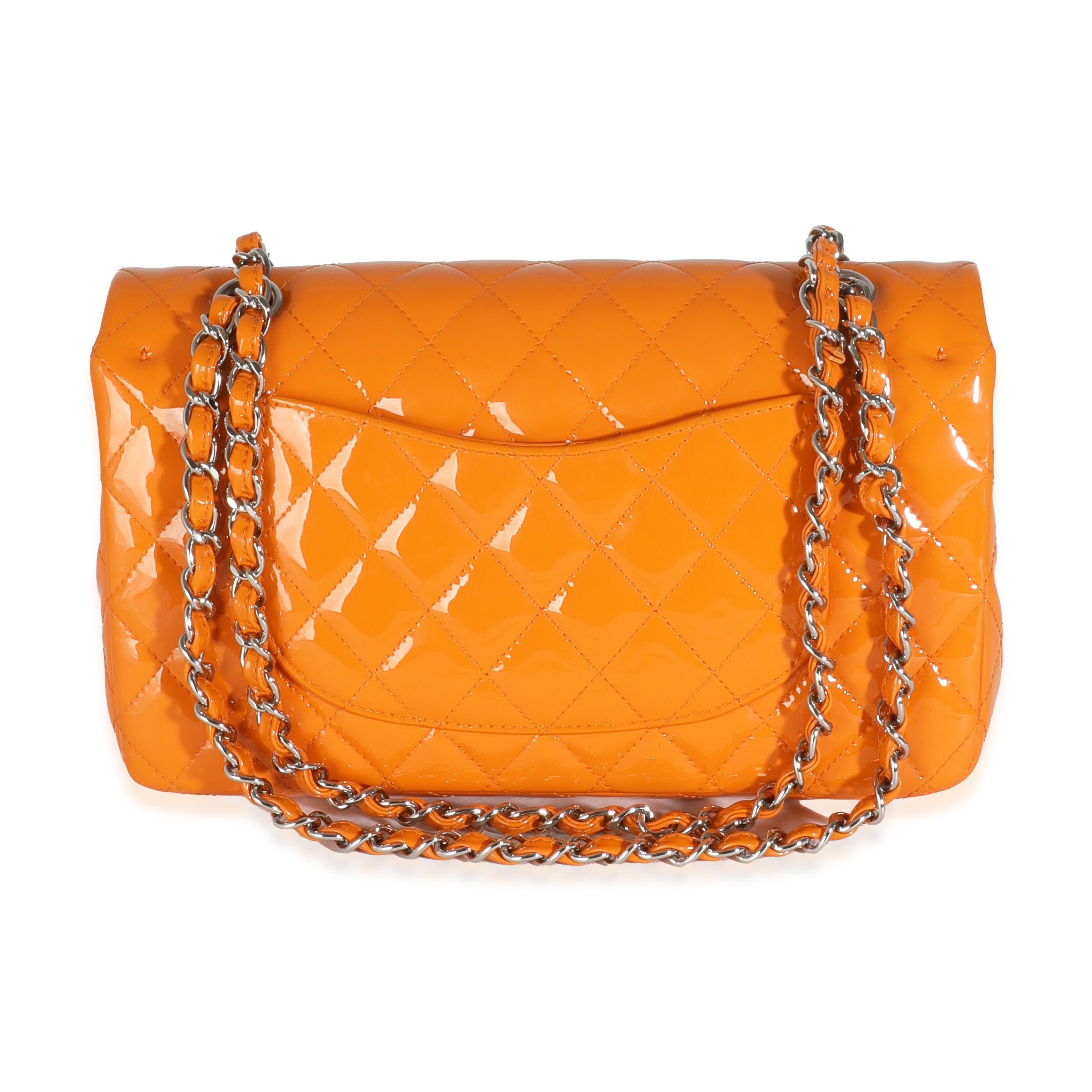 Listing Title: Chanel Orange Quilted Patent Medium Classic Double Flap Bag
SKU: 143768
Condition: Pre-owned 
Condition Description: A timeless classic that never goes out of style, the flap bag from Chanel dates back to 1955 and has seen a number of