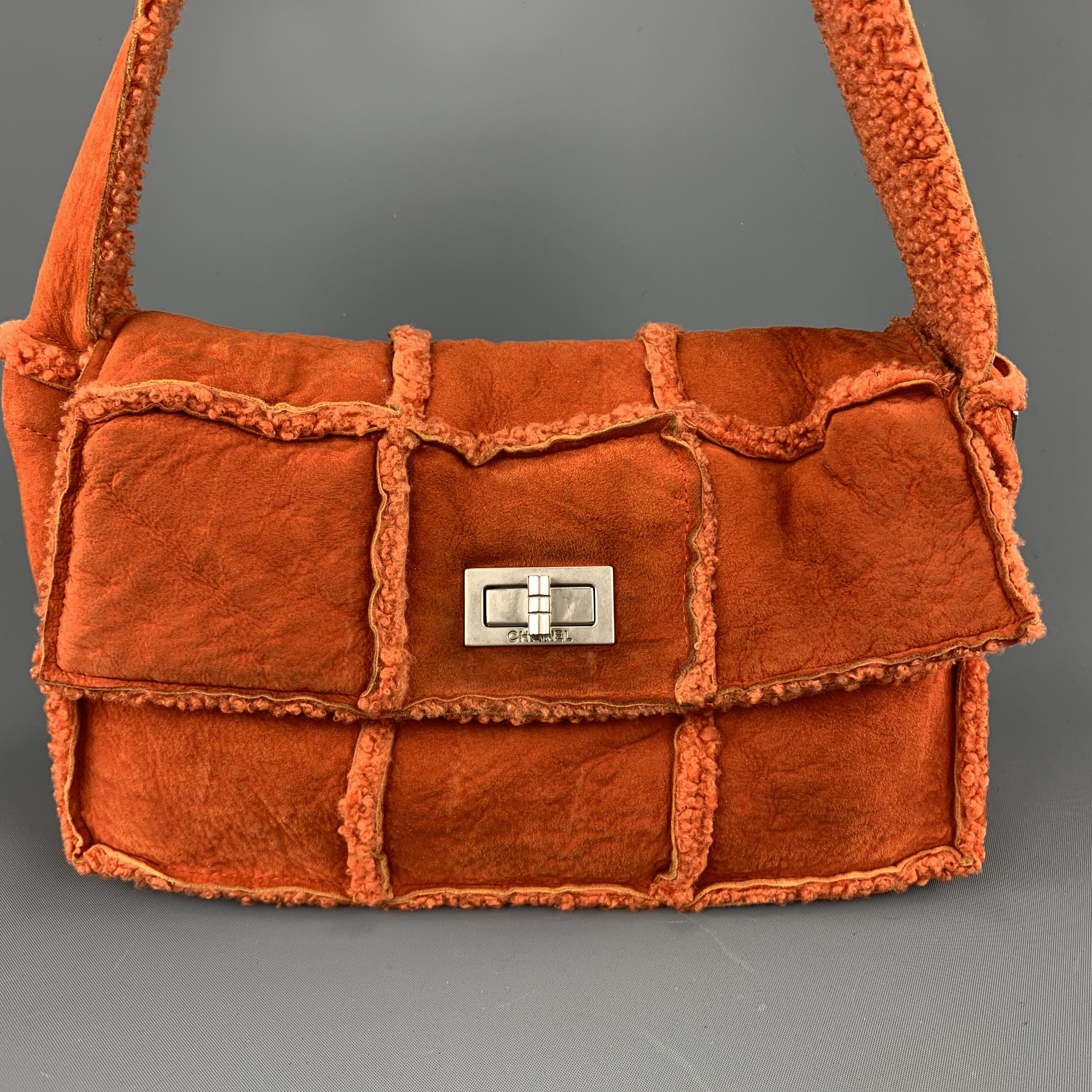 Archive CHANEL shoulder bag comes in orange shearling with fur and features a patchwork quilted structured with flap closure, silver tone turn lock, interior pockets and thick shoulder strap. Wear throughout. As-is. Made in France.
 
Good Pre-Owned