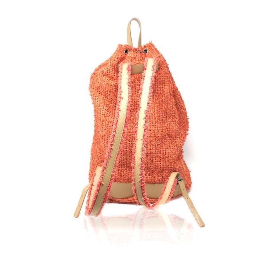 Really Nice Chanel Orange Tweed Coco Cuba Backpack Bag. In excellent condition it is worn on the shoulder, in perfect condition, bag closure with chain and CC logo charm, super stylish and comfortable to travel. Super sold out, very rare, in orange