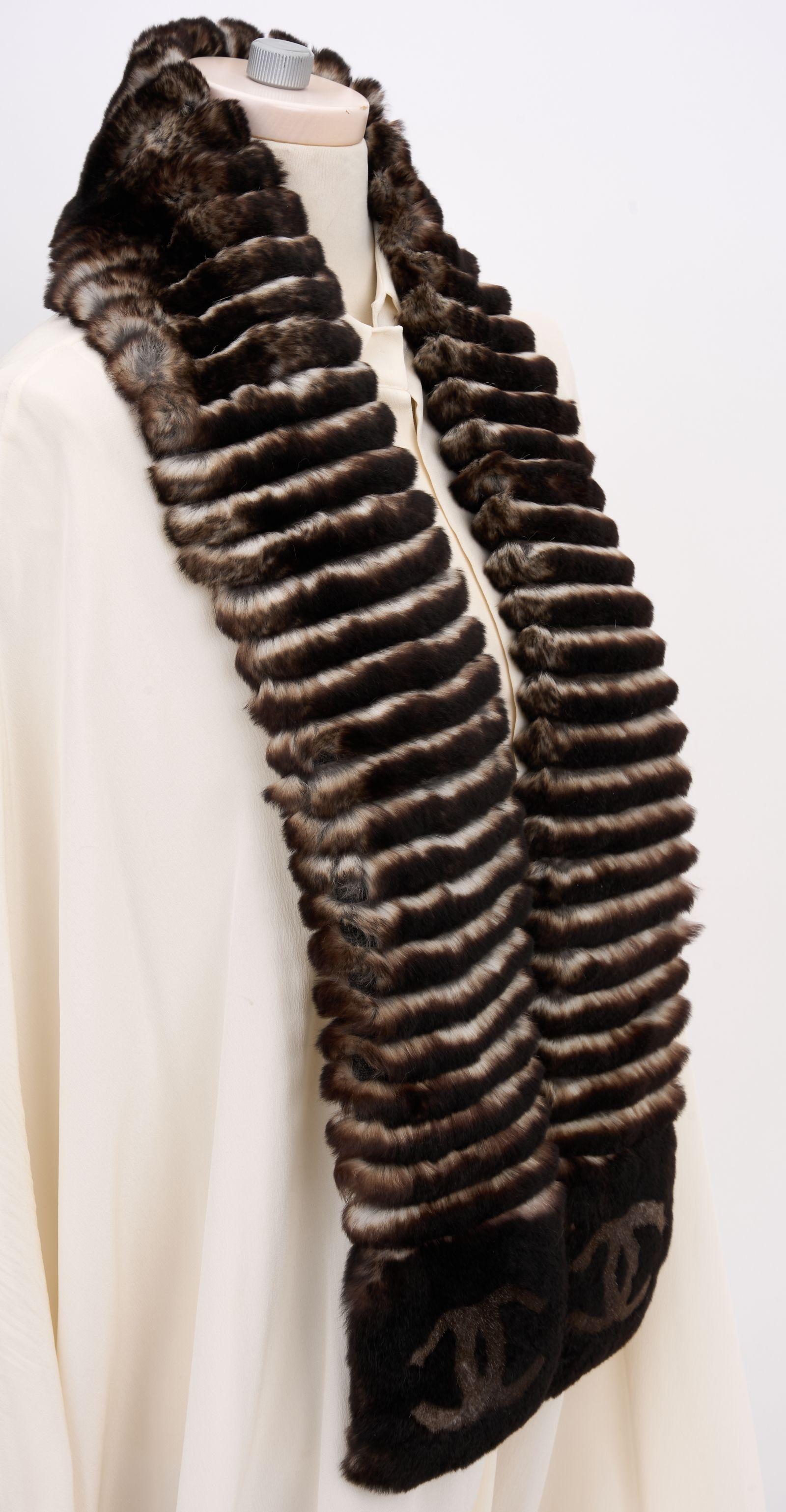 This Chanel Orylag Fur brown Logo Scarf is crafted with high-quality fur and the CC logo is featured at each end of the scarf. Brand new in unused condition.