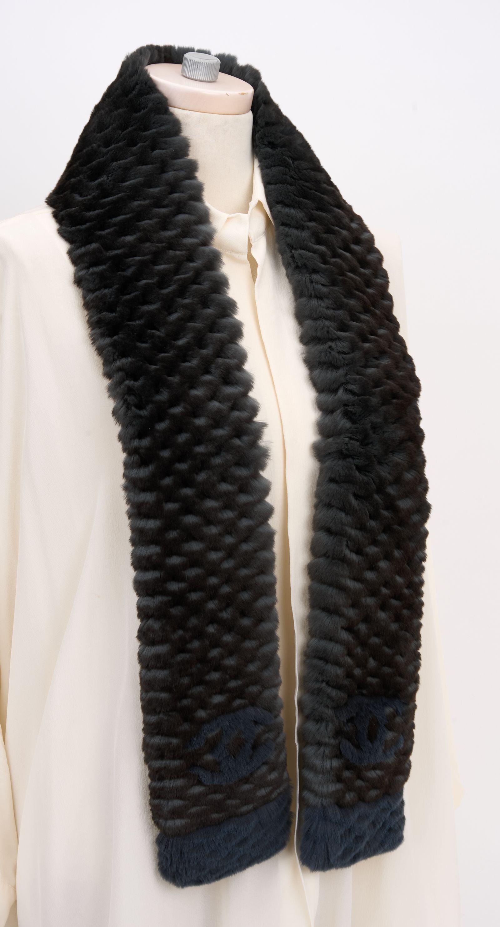 This Chanel Orylag Fur Two-Tone Logo Scarf is the perfect combination of sophistication and elegance.  Blue trim edges and CC logos are featured at each end of this scarf making it versatile with any outfit. Brand new in unused condition.