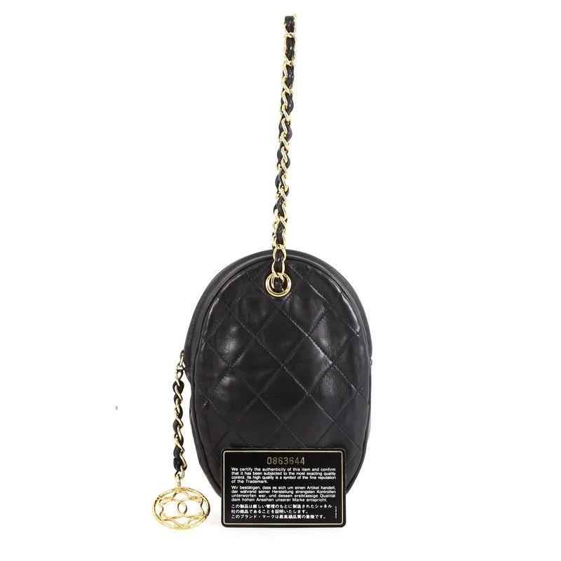 This Chanel Oval CC Charm Clutch Quilted Leather Small, crafted from black quilted leather, features woven in leather chain strap and gold-tone hardware. Its zip closure opens to a black leather interior. Hologram sticker reads: 0863644. 

Estimated