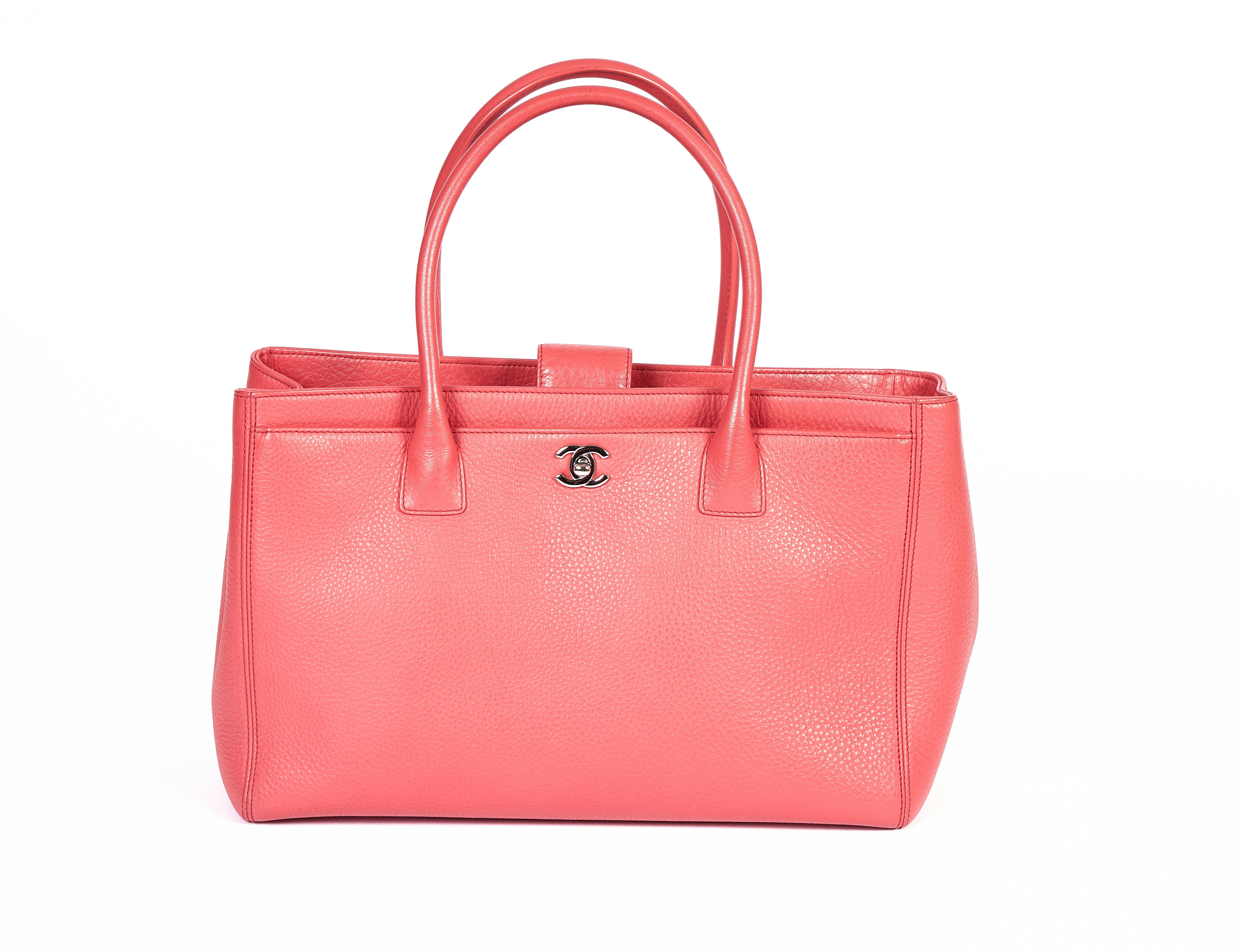 This beautiful City bag from Chanel comes in a coral color which looks good with a business outfit as well as jeans. The handles have a drop of 7 inches so you can also wear it over your shoulder. Detachable interior pouch and strap. It comes with