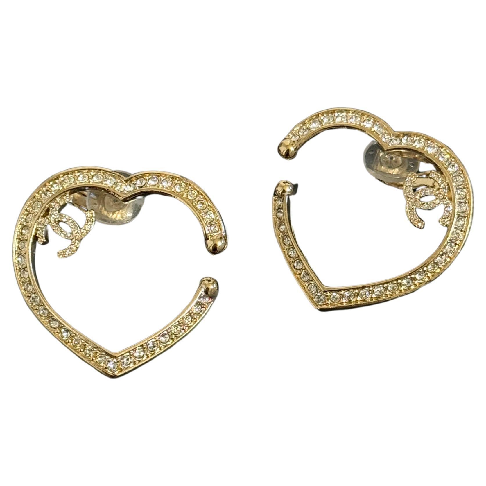 Orecchini Chanel oversize con cuore di cristallo e logo CC in oro con chiusura a clip