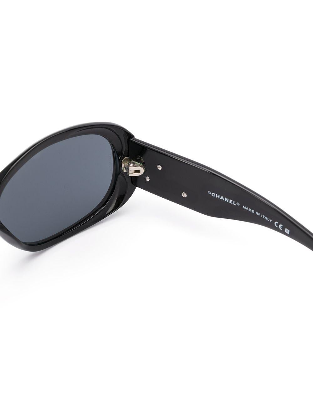 Crafted in France from pure black acetate, these sunglasses elevate a classic silhouette with round, oversized-frames, tinted lenses and straight arms with curved tips.

This item includes its original leather protective Chanel case and lens