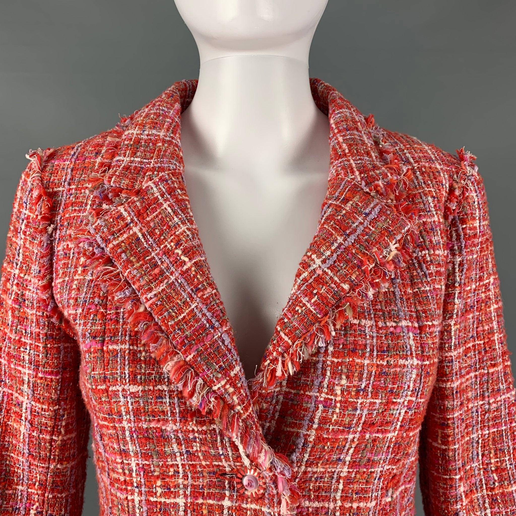 CHANEL 2004 jacket comes in a red and white boucle cotton blend with a full monogram liner featuring a notch lapel, chanel logo buttons detail, and a three button closure. Made in France. Excellent Pre-Owned Condition.  

Marked:   P23159V13825 36