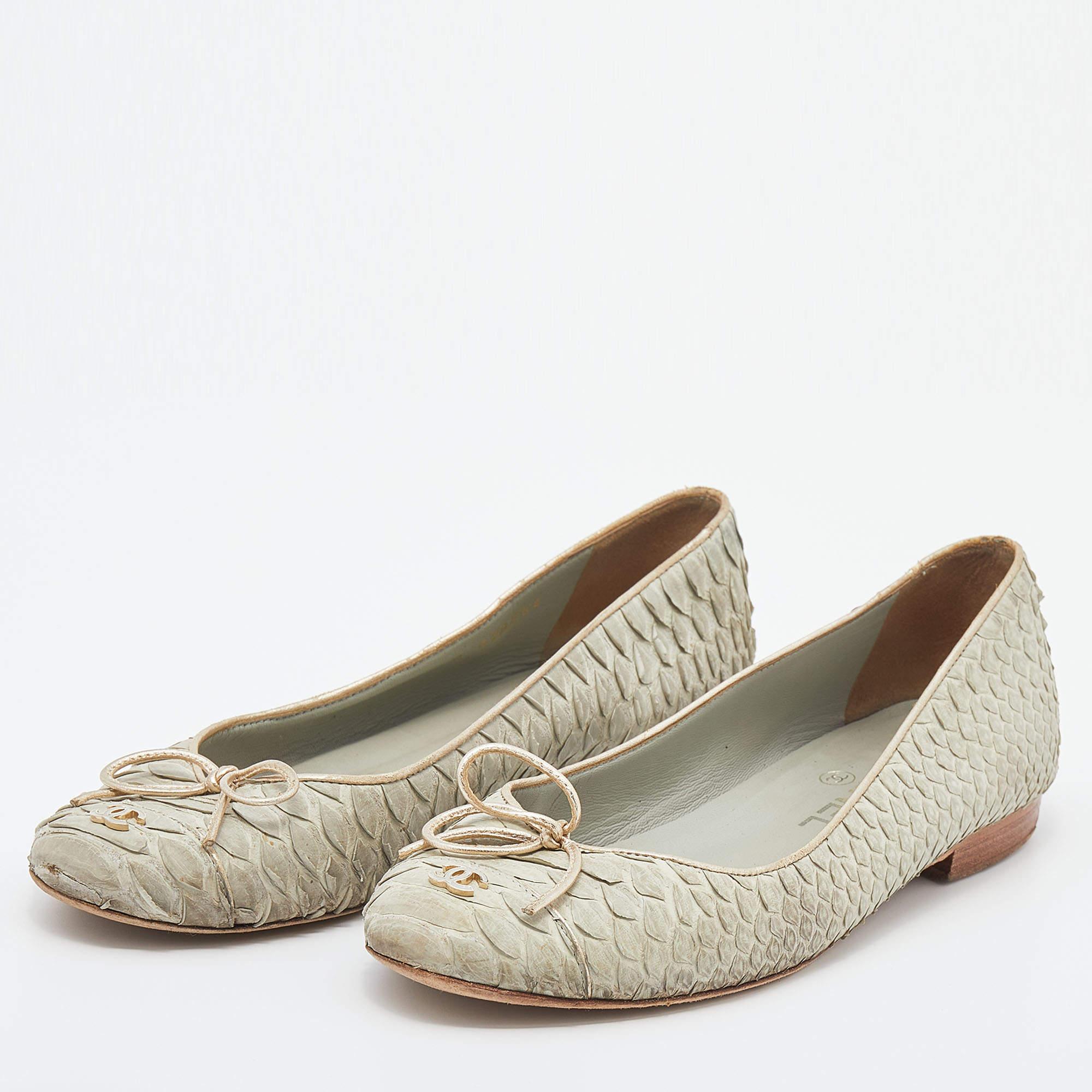A common sight in the closets of fashionistas is a pair of Chanel ballet flats. They are perfect to wear on busy days and just chic enough to assist one's style. These flats are crafted from pale green python leather and feature the iconic CC logo