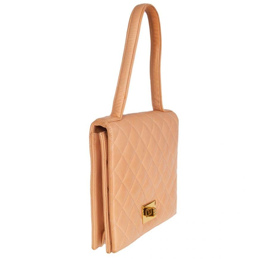 Chanel Vintage quilted flap handbag in pale salmon lambskin. Opens with a gold-tone turn look to a calfskin leather interior with one zipper pocket and one open pocket against the back. Has lipstick mirror under the flap. Has been worn and is in