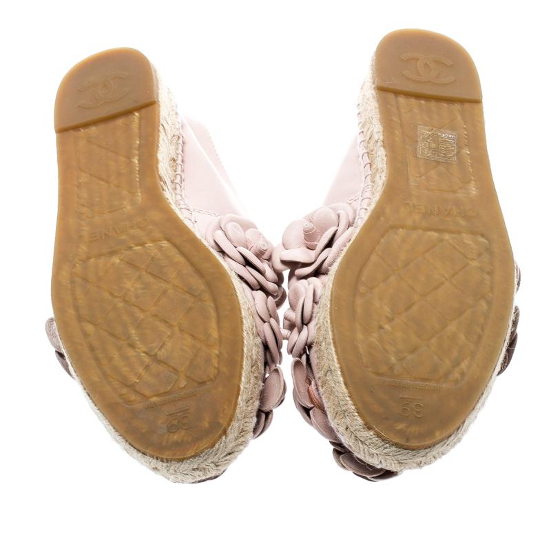 Radiate your fashionable self even in your casuals by owning these espadrilles from Chanel. They've been crafted from leather in a pale pink hue while being styled with the signature Camellia flowers all over the vamps and braided details on the