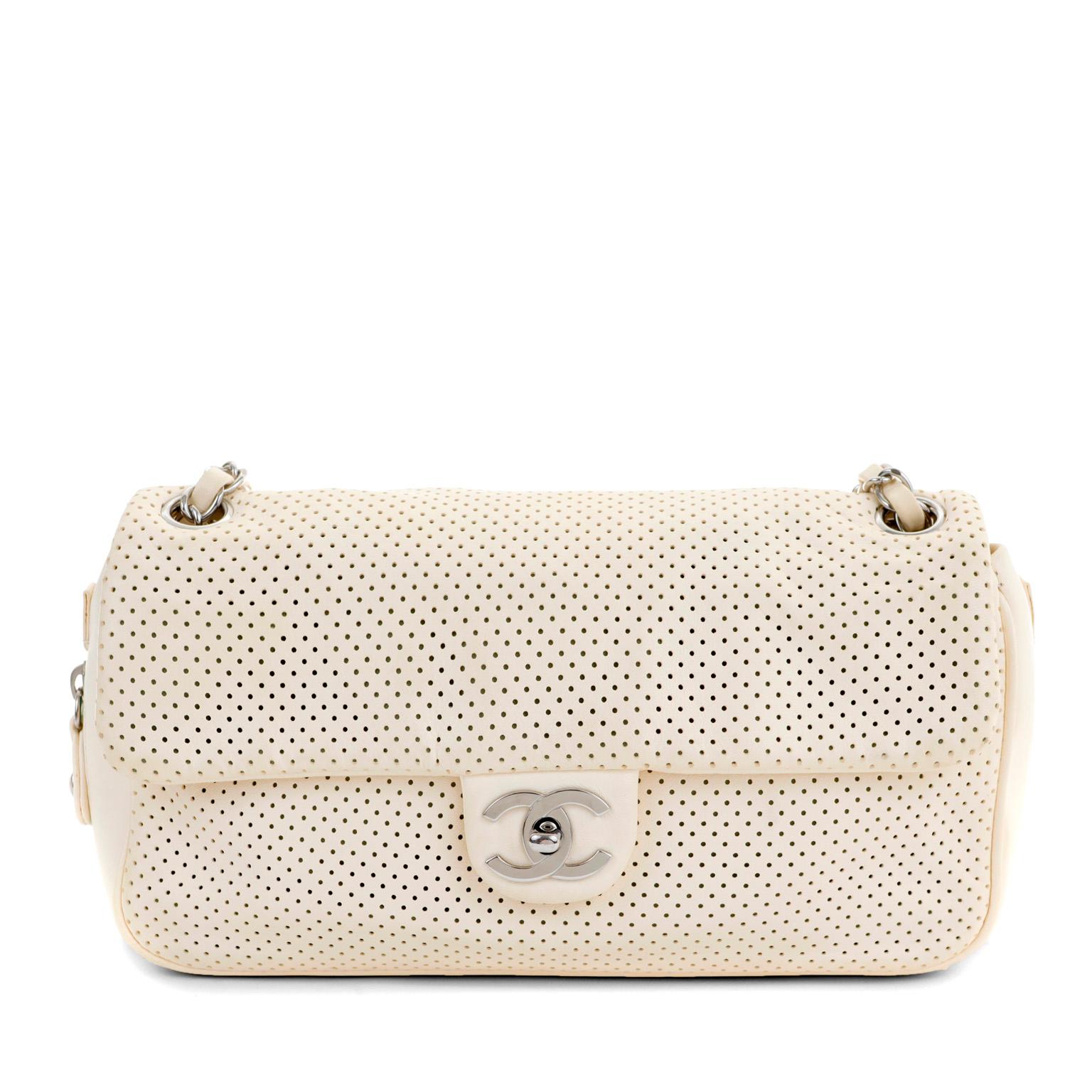 This authentic Chanel Pale Yellow Perforated Leather Baseball Spirit Flap Bag is in excellent plus condition. Perfectly scaled in the medium silhouette, this flap bag is ready to go anywhere day or evening.  Pale yellow perforated leather flap bag