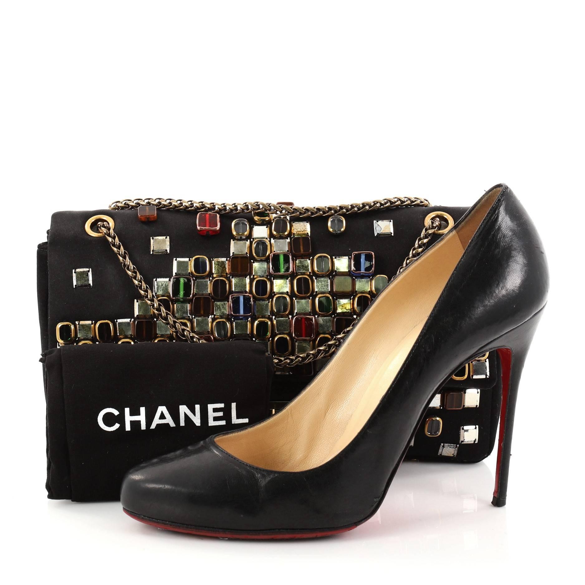 This authentic Chanel Paris-Byzance Reissue 2.55 Handbag Embellished Satin 225 is an elegant and timeless piece to add to any collection. Crafted from black satin with with multi-color gripoix beads & metal sequins, this stand-out flap features