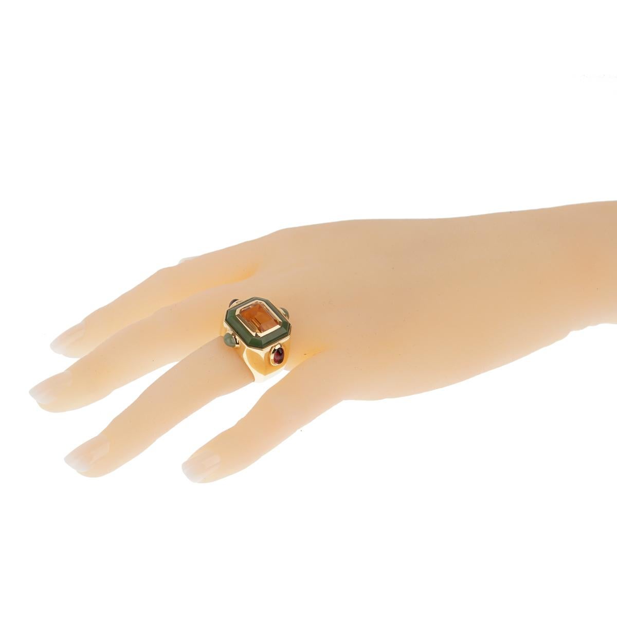 A very chic cocktail ring by Chanel that features a golden emerald cut citrine, and carved jade in 18k yellow gold. 

Size 5 1/2
Width: 1.05